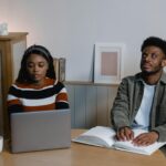 Individuals engage with technology and braille, highlighting inclusivity.